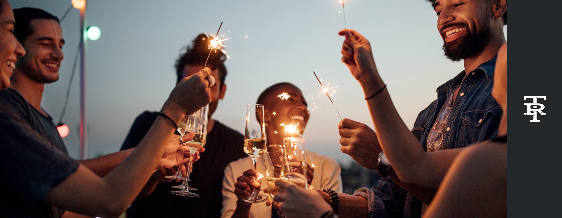 Lifestyle photo of friends with drinks and sparklers